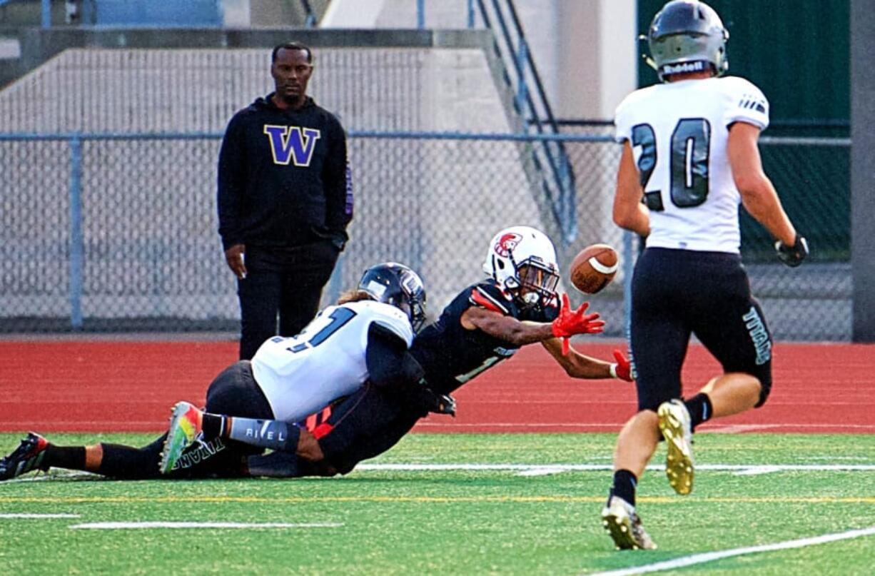 Union&#039;s Logan Wilson, left, knocks the ball loose from Steilacoom&#039;s Isaiah Devane at the Titans&#039; 2-yard line. Tyler Summers (20) recovers and returns the ball to Sentinel territory.