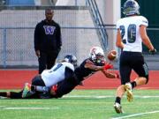 Union&#039;s Logan Wilson, left, knocks the ball loose from Steilacoom&#039;s Isaiah Devane at the Titans&#039; 2-yard line. Tyler Summers (20) recovers and returns the ball to Sentinel territory.