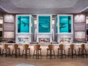 Damien Hirst’s sculpture of a 13-foot tiger shark preserved in three tanks floats atop the The Palms’ Unkown Bar and also inspired the name of Bobby Flay’s new restaurant.