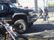 A photographer dives out of the way of a truck driven by William Donald &quot;Billy&quot; Wilson after a rally held by Joey Gibson&#039;s Patriot Prayer Group in Vancouver on Sept. 10, 2017. A judge on Tuesday dropped misdemeanor charges against Wilson in connection with the incident.