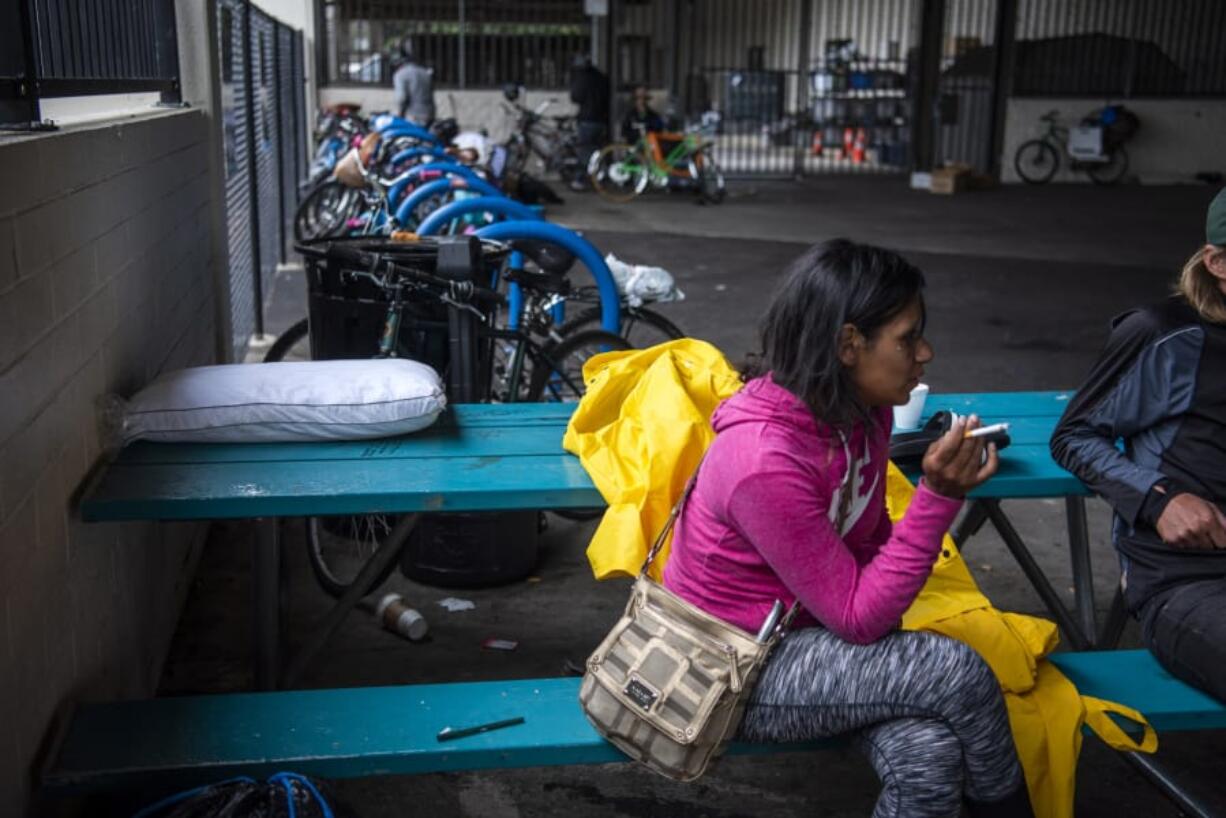 Chynna Lee smokes outside the Vancouver Navigation Center on June 27. Lee said she has been homeless for a few years and was a frequent patron of the center.