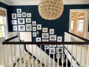 A family photo wall designed by Ashley Whittaker for a Connecticut client.