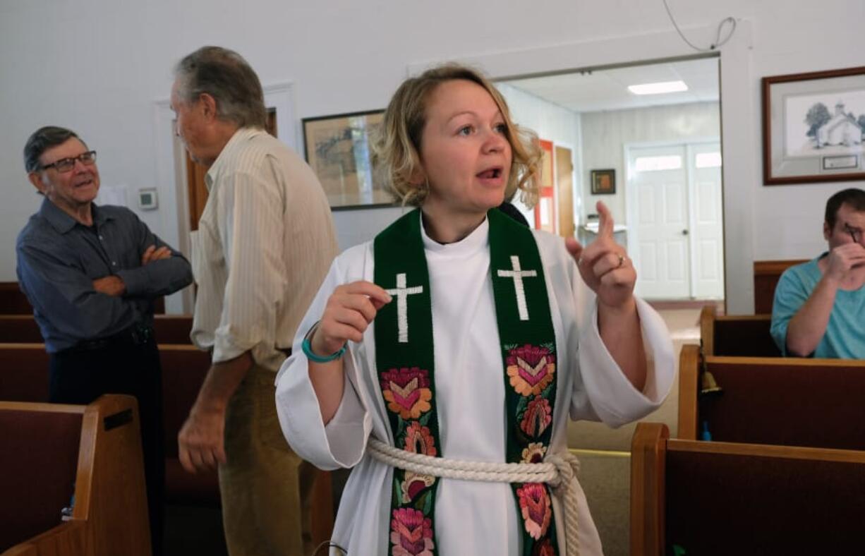 The Rev. Jess Felici speaks with parishioners at New Hope Lutheran Church in Upper Ract, W.V. before the first of three services she&#039;ll officiate. Felici and her husband Jason travel to five different services each Sunday that are part of the Mountain Lutheran Parish.