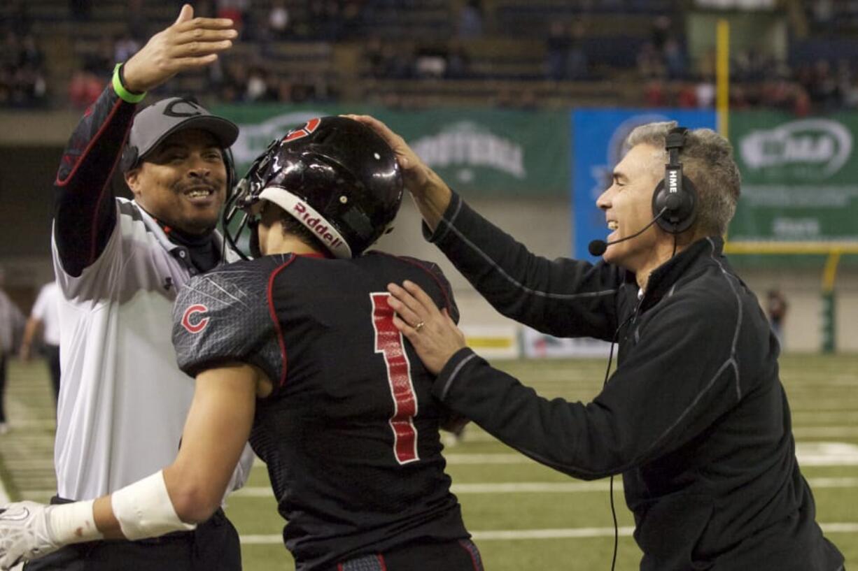 Camas coach Jon Eagle, right, celebrates a fumble recovery in the Papermakers&#039; 2013 state championship game in the Tacoma Dome.