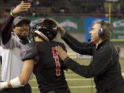 Camas coach Jon Eagle, right, celebrates a fumble recovery in the Papermakers&#039; 2013 state championship game in the Tacoma Dome.