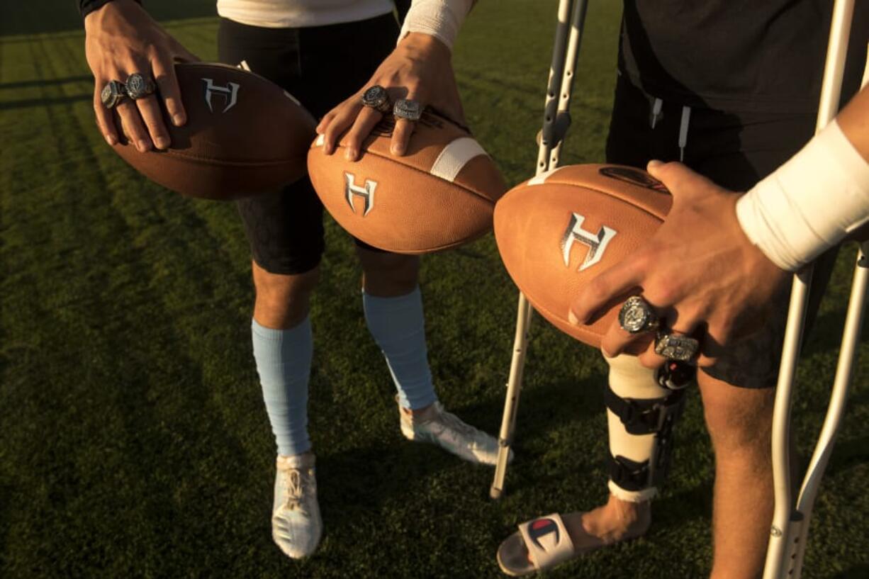 Hockinson players Sawyer Racanelli and Peyton Brammer show off their state-championship rings.