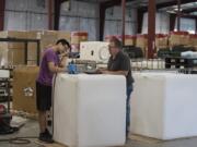 Erick Chavez, left, details a wine tank made of polyethylene while working with colleague Steve Downing at the newly expanded SmaK Plastics in Vancouver. A recent expansion nearly tripled the working floor space.