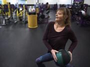 Kris Houston uses a medicine ball to work out at Planet Fitness in Hazel Dell. Houston has started working out four to five times a week since entering the Washington State University Clark County Extension Diabetes Prevention Program last year.