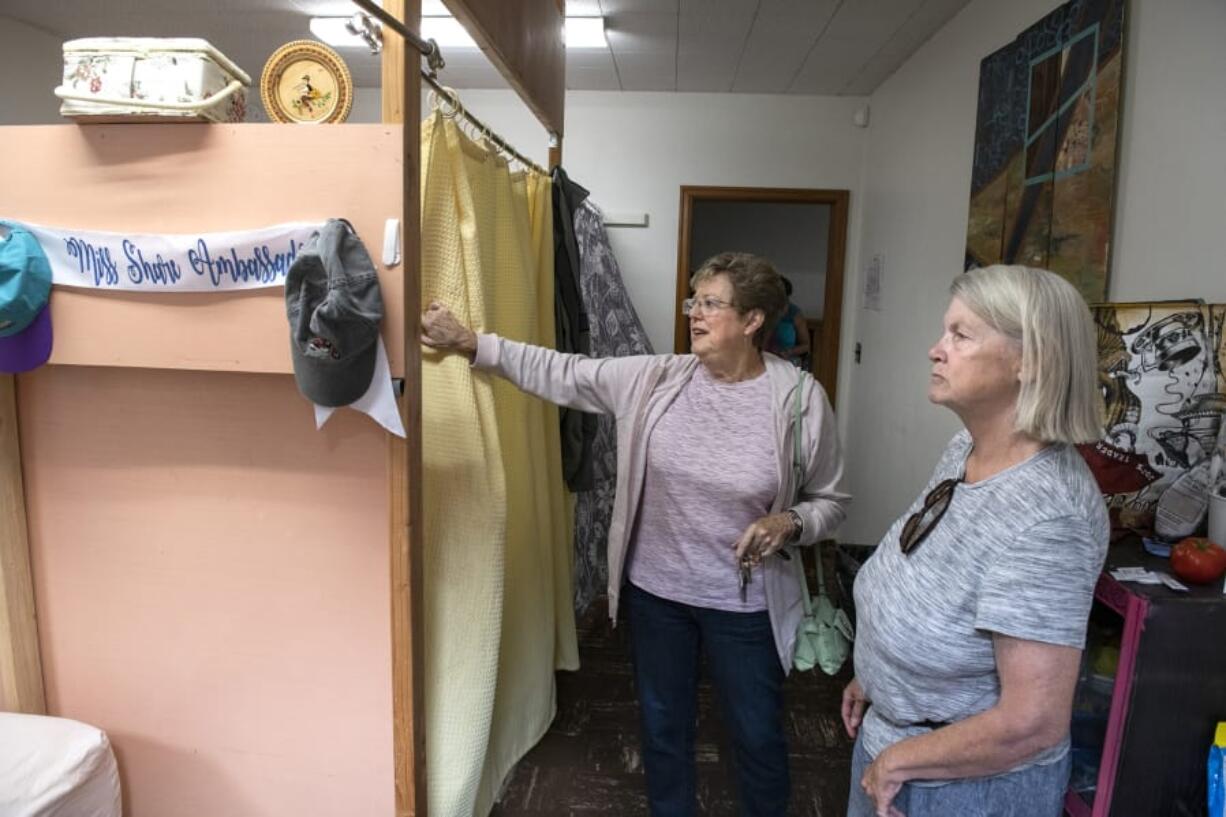 Women’s Housing and Transition shelter client Deborah Brown, right, gives a tour of a sleeping area with church liaison Kathy Gallaher. Brown will soon be leaving the shelter at St. Luke’s–San Lucas Episcopal Church and moving into housing but plans to continue volunteering in the homeless community.