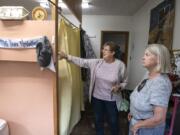 Women’s Housing and Transition shelter client Deborah Brown, right, gives a tour of a sleeping area with church liaison Kathy Gallaher. Brown will soon be leaving the shelter at St. Luke’s–San Lucas Episcopal Church and moving into housing but plans to continue volunteering in the homeless community.