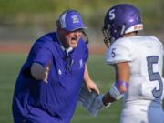 Heritage head coach Dennis Moody celebrates a touchdown with Isaac Roa (5) during the Timberwolves’ season opener at McKenzie Stadium on Friday evening.