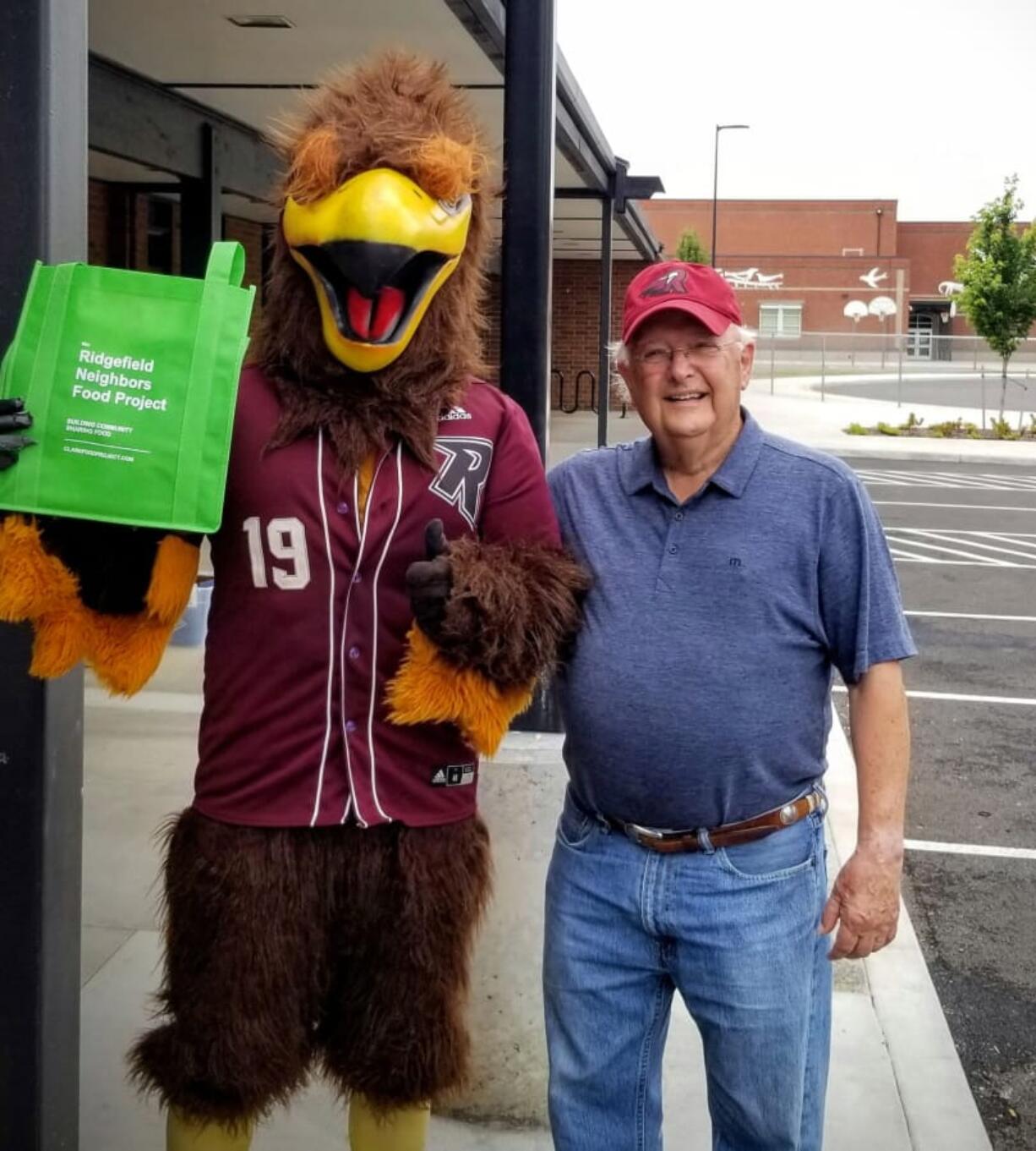 Ridgefield: Rally the Raptor with Clyde Burkle, a member of the leadership team of Ridgefield Neighbors Food Project. The group’s August collection event featured Rally and two Raptors players.