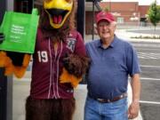 Ridgefield: Rally the Raptor with Clyde Burkle, a member of the leadership team of Ridgefield Neighbors Food Project. The group’s August collection event featured Rally and two Raptors players.