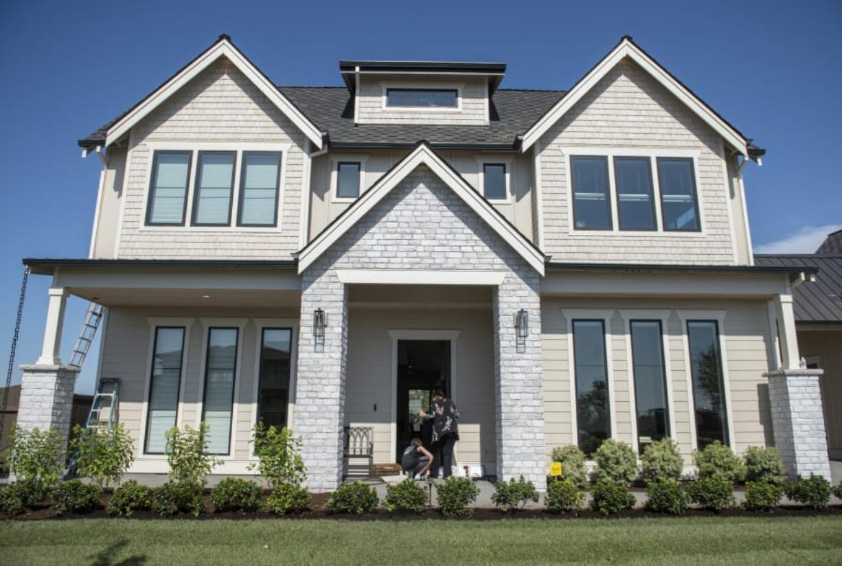 Guests take off their shoes before entering one of the houses on display at the NW Natural Parade of Homes in Camas on Thursday afternoon. The house was built by Affinity Homes.