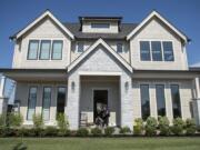 Guests take off their shoes before entering one of the houses on display at the NW Natural Parade of Homes in Camas on Thursday afternoon. The house was built by Affinity Homes.