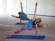 Valerie Hunt of Vancouver moves into the compass pose at Bikram Yoga Hazel Dell. Hunt restarted practicing yoga about six years ago, after taking a long break from yoga due to a back injury, and did her first competition the year after. She has finished in the top 10 of national competitions.