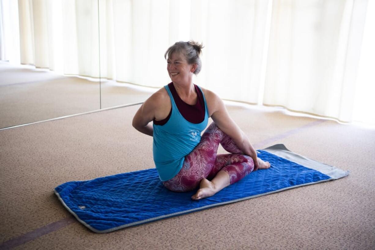 Valerie Hunt Vancouver moves into a spinal twist at Bikram Yoga Hazel Dell and Hot Yoga North West in Vancouver. Hunt said yoga keeps her present. "When I'm training, when I'm doing hot yoga, I'm not thinking about work, I'm not thinking about the dogs or my family, anything," she said.