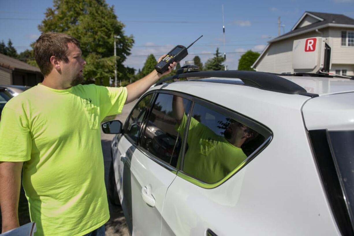 Joe Cryblskey, a Clark Public Utilities AMR (automated meter reading) driver, explains how the automated meter reading is used to track customer usage, while covering his route in the Salmon Creek neighborhood.