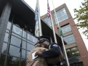 U.S. Army Veteran David Cohrs, left, and Vancouver Police Officer Rey Reynolds share a hug following the Patriot Day Salute in front of Vancouver City Hall on Wednesday morning.