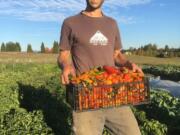 Co-owner Patrick Dorris showcases the bounty of Flat Tack Farms, which is hosting a farm-to-table dinner Sept. 21.