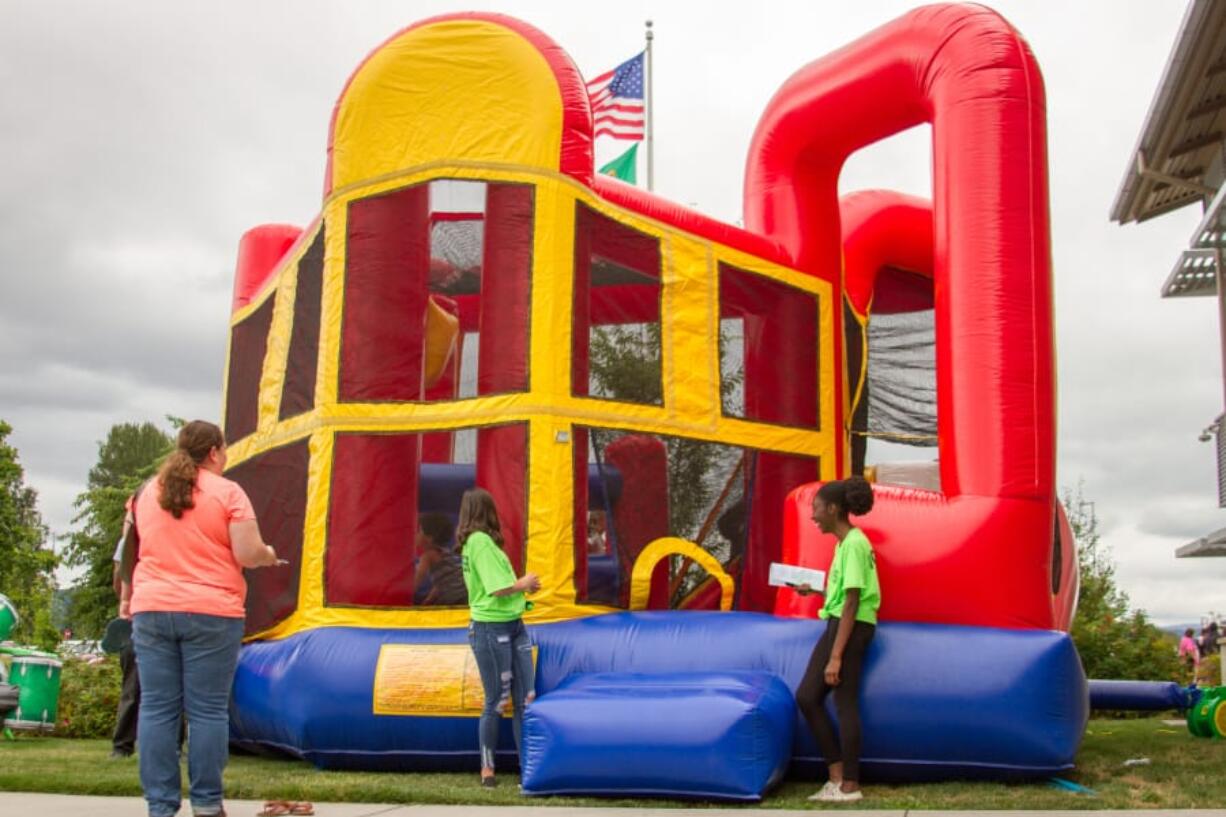 In addition to handing out backpacks filled with school supplies, Woodland Public Schools&#039; third annual Back to School Bash also allowed kids to play in bounce houses.