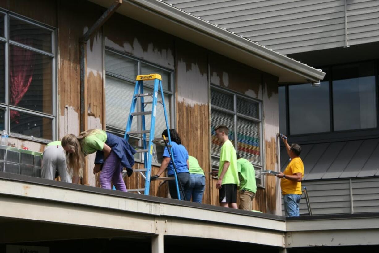 More than 80 volunteers from various local congregations joined together for a volunteer project scraping loose paint and putting primer on the resulting bare wood of the exterior walls of the Winter Hospitality Overflow shelter.