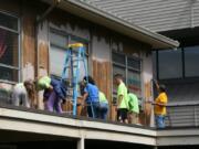 More than 80 volunteers from various local congregations joined together for a volunteer project scraping loose paint and putting primer on the resulting bare wood of the exterior walls of the Winter Hospitality Overflow shelter.