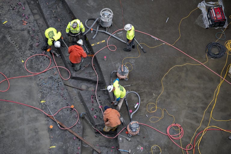 Contracted workers from Advanced American Construction, Inc., lend a hand as they work to replace the sill at Bonneville Navigation Lock on Wednesday morning, Sept. 18, 2019. The Army Corps of Engineers hosted a tour at the lock to show off the emergency repair project.