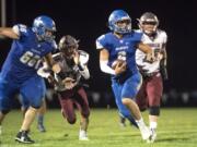 La Center Quarterback Tom Lambert scrambles under pressure from Hoquiam during a game at La Center High School on Friday night, Sept. 20, 2019.