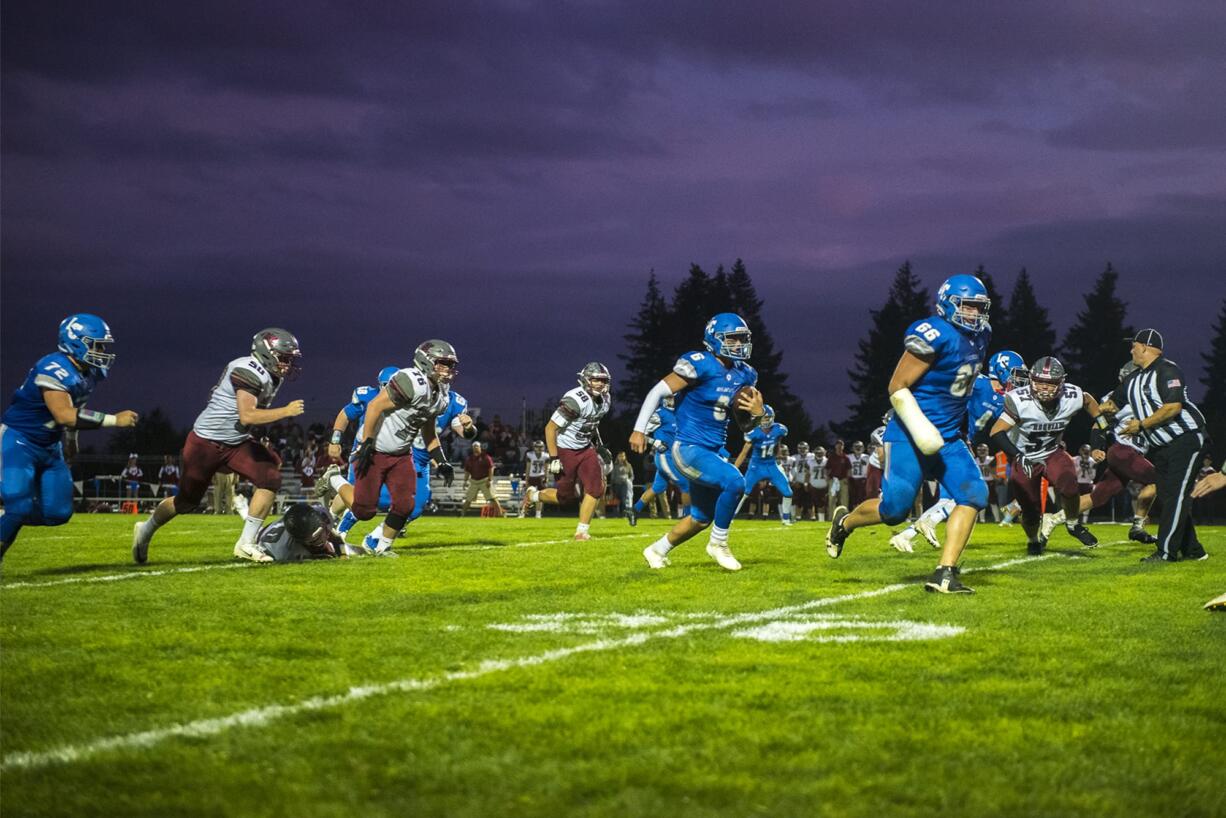 La Center Quarterback Tom Lambert runs the ball against Hoquiam at La Center High School on Friday night, Sept. 20, 2019.