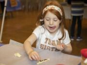 Emily Dresher, 5, creates challah bread at a kids farmers market Sunday morning at the Chabad Jewish Center of Clark County in Brush Prairie.