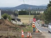 Flagger Hailey David monitors traffic as it drives past the construction site on Northwest Brady Road  in Camas on Monday.