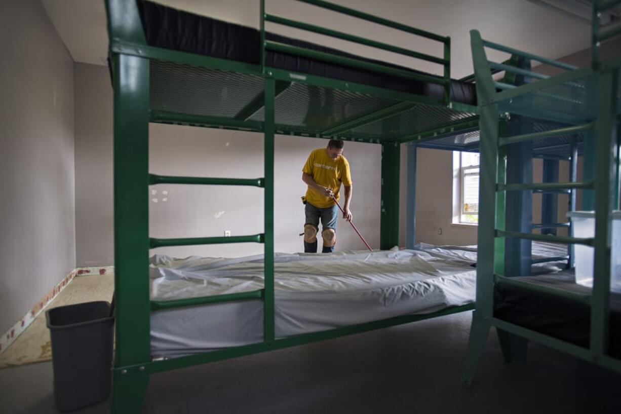 Bryan Swett of Nowland Floor Covering Inc. cleans a bedroom at Share House, the men&#039;s shelter in downtown Vancouver that&#039;s being renovated after water damage from a fire shuttered the shelter.