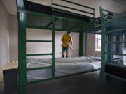 Bryan Swett of Nowland Floor Covering Inc. cleans a bedroom at Share House, the men&#039;s shelter in downtown Vancouver that&#039;s being renovated after water damage from a fire shuttered the shelter.