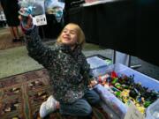 Natalie Parker, 6, of Vancouver shows off a figurine she found in a dollar bin Sunday afternoon.