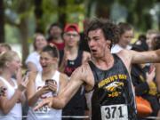 Hudson Bay's Brian Loop emerges from the water hazard during the Steve Maas Hudson's Bay Run-A-Ree cross country meet at Hudson's Bay High School on Friday afternoon, September 13, 2019.