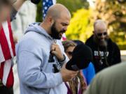 Joey Gibson, leads supporters in prayer on the steps of the Capitol Building in Salem, Ore. following the conclusion of a flag waving rally in October 2017. Gibson, the leader of Patriot Prayer, is extremely active on social media, where he has attracted a large following.