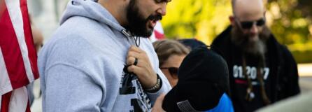 Joey Gibson, leads supporters in prayer on the steps of the Capitol Building in Salem, Ore. following the conclusion of a flag waving rally in October 2017. Gibson, the leader of Patriot Prayer, is extremely active on social media, where he has attracted a large following.