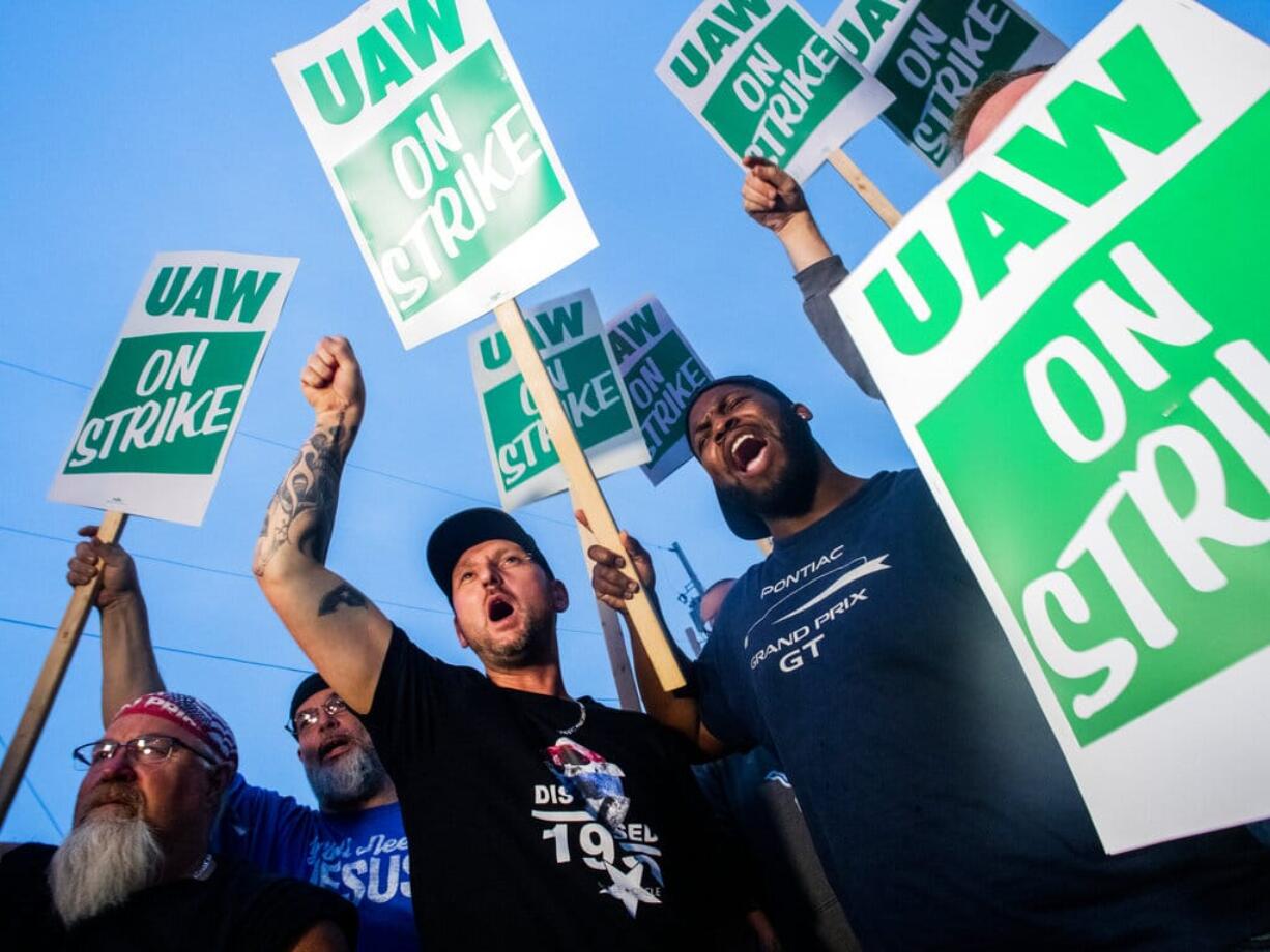 General Motors employees Bobby Caughel, left, and Flint resident James Crump, shout out as they protest with other GM employees, United Auto Workers members and labor supporters outside of the Flint Assembly Plant on Monday, Sept. 16, 2019 in Flint, Mich. Thousands of members of the United Auto Workers walked off General Motors factory floors or set up picket lines early Monday as contract talks with the company deteriorated into a strike.