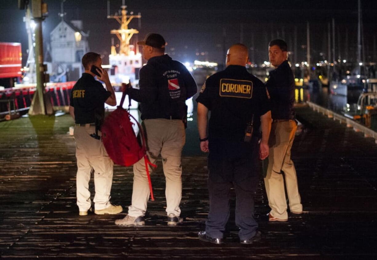 Local law enforcement and coroners work to retrieve the bodies found by diving teams after a deadly fire on the boat Conception, Monday, Sept. 2, 2019, in Santa Barbara, Calif. A fire raged through a boat carrying recreational scuba divers anchored near an island off the Southern California coast early Monday, leaving multiple people dead and hope diminishing that any of the remaining people still missing would be found alive.