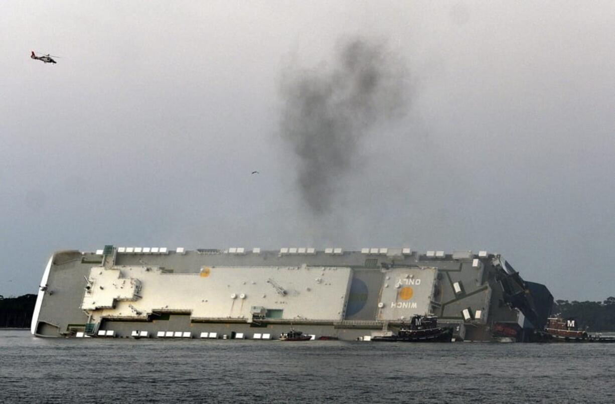 Smoke rises from a cargo ship that capsized in the St. Simons Island, Georgia sound Sunday, Sept. 8, 2019.