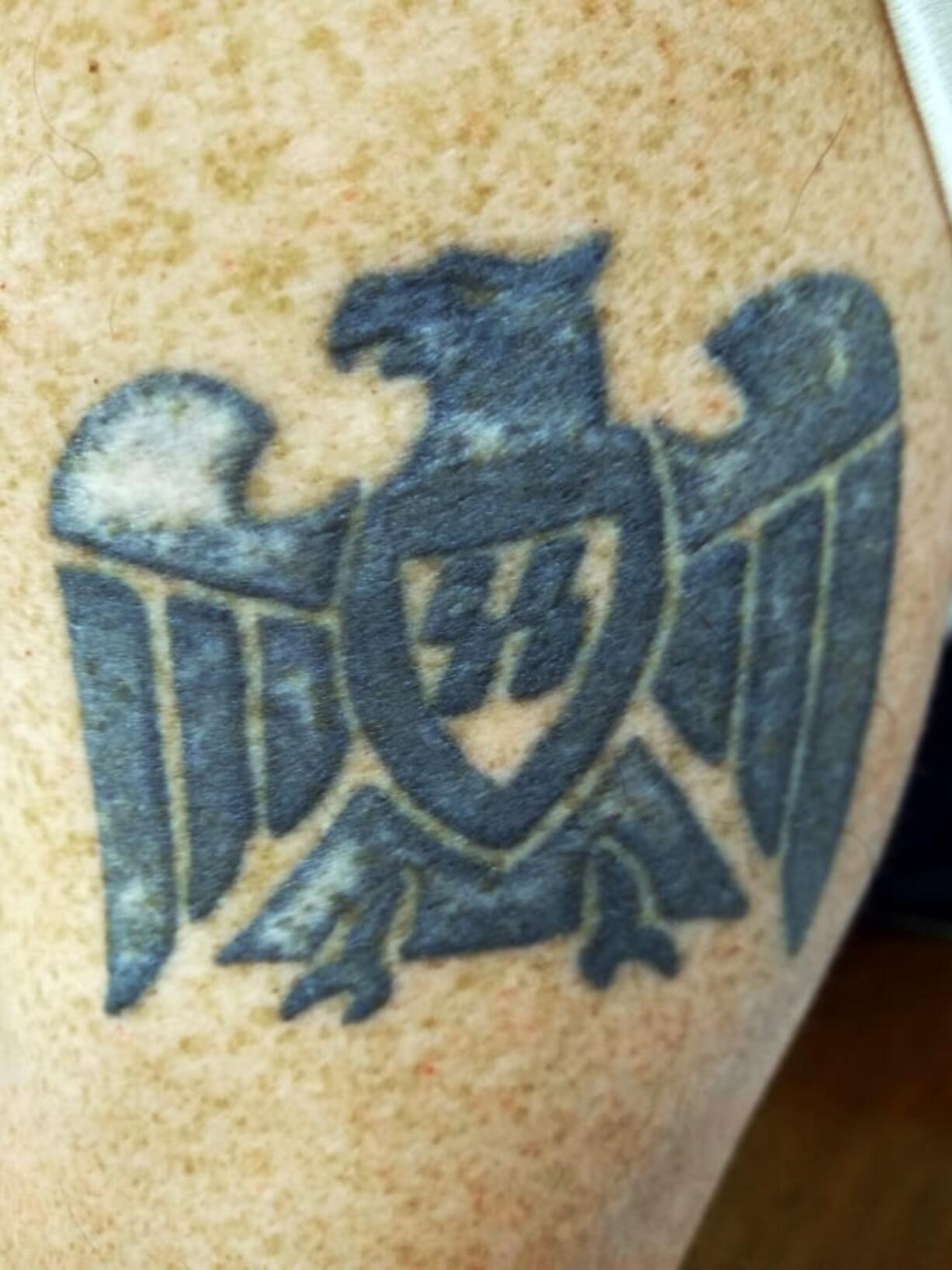 Bradford Devlin, a supervisor in the Seattle office of the Bureau of Alcohol, Tobacco, Firearms and Explosives, displays his Nazi-themed tattoo during a deposition in Seattle.