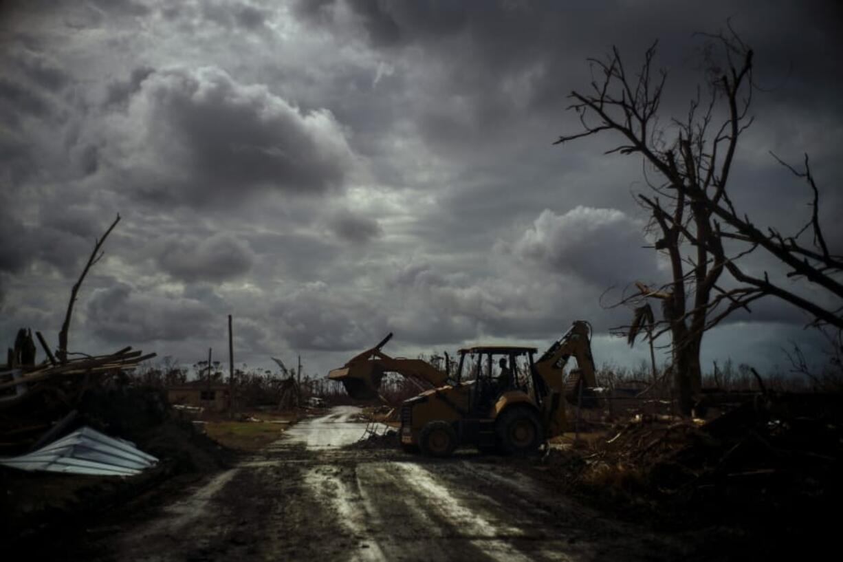 Mos Antenor, 42, drives a bulldozer while clearing the road after Hurricane Dorian Mclean&#039;s Town, Grand Bahama, Bahamas, Friday Sept. 13, 2019.