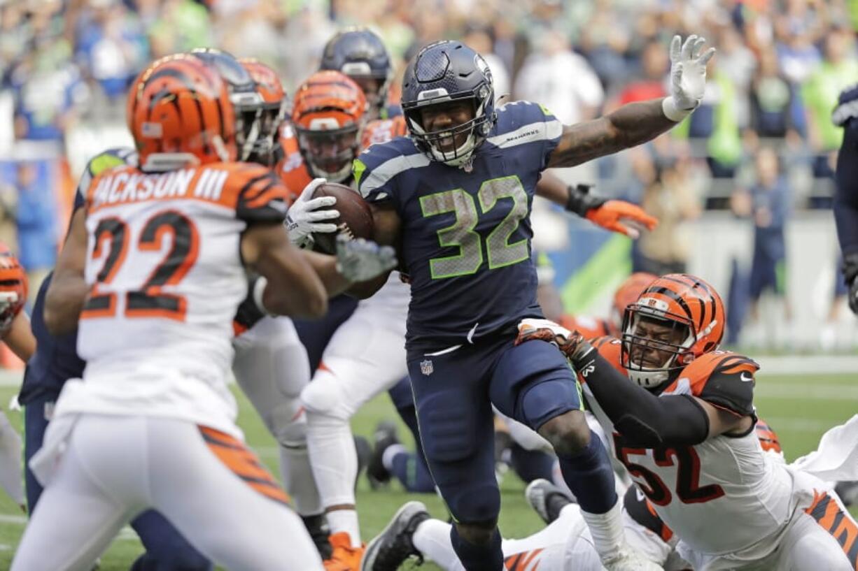 Seattle Seahawks running back Chris Carson (32) rushes against the Cincinnati Bengals during the second half of an NFL football game, Sunday, Sept. 8, 2019, in Seattle.