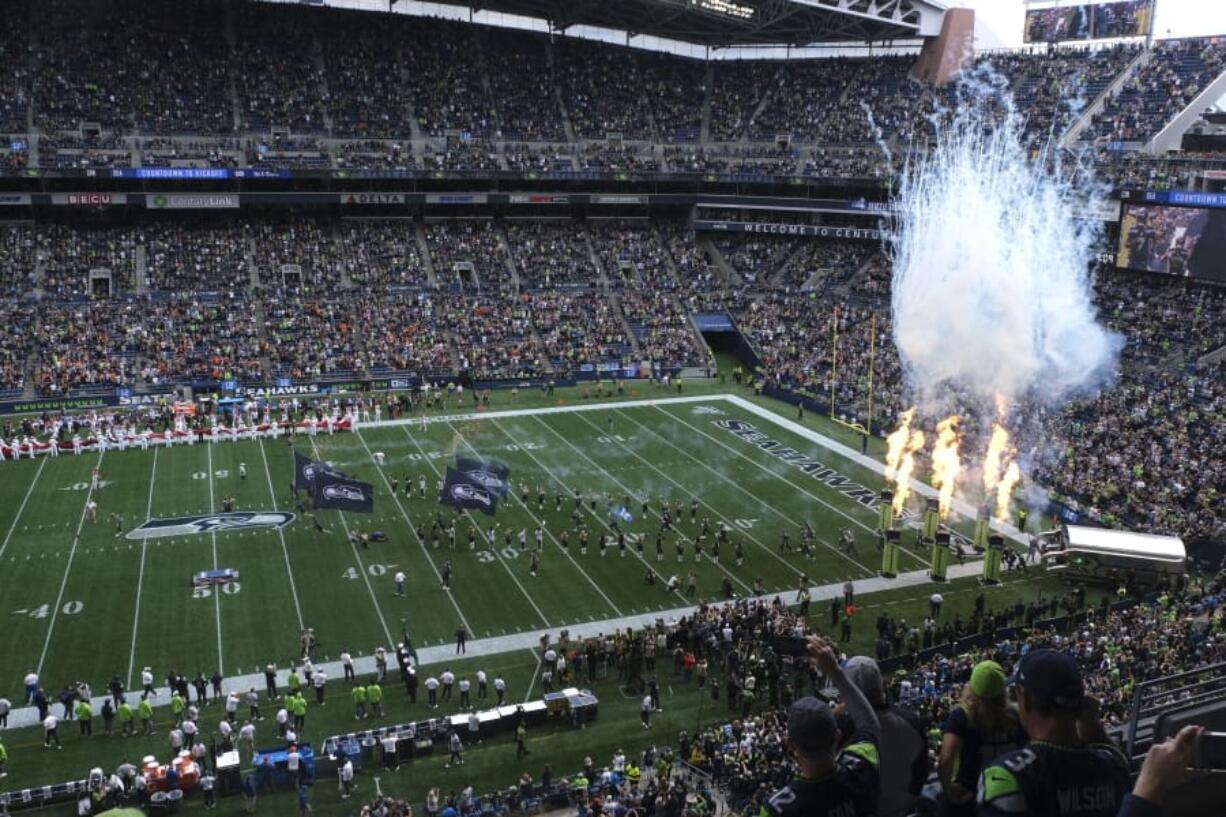 Fire effects go off as Seattle Seahawks players run out of the tunnel at the start of their home opener NFL football game against the Cincinnati Bengals at CenturyLink Field, Sunday, Sept. 8, 2019, in Seattle.