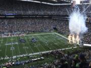 Fire effects go off as Seattle Seahawks players run out of the tunnel at the start of their home opener NFL football game against the Cincinnati Bengals at CenturyLink Field, Sunday, Sept. 8, 2019, in Seattle.