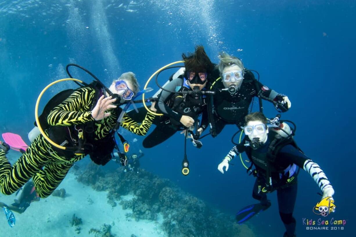 This November 2018 photo shows, from left, Diana Ademic, Berenice Felipa, Steve Salika and Tia Salika off the coast of Venezuela. All four were aboard the dive boat Conception and all died in the fire that swept the vessel.