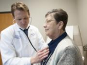 Cardiologist Dr. Nathan Boyer follows up with patient Sharon Parks at Vancouver Clinic in 2016. Parks, 69, was the first patient in Clark County to undergo a new cardiac procedure called TAVR. The procedure was initially only available to the most high-risk patients, but has been expanded to all risk levels.