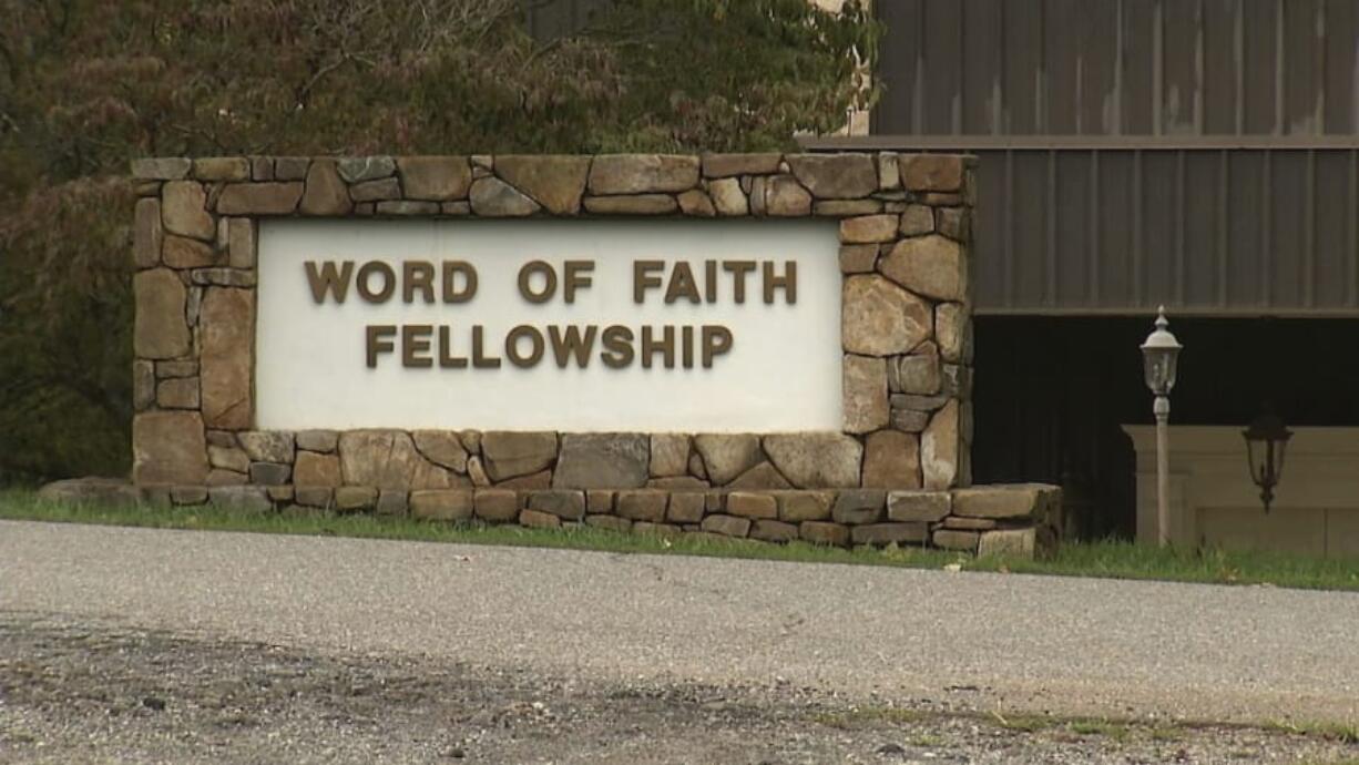 FILE - This 2016 image from video shows the entrance to the Word of Faith Fellowship church in Spindale, N.C. A member of the secretive North Carolina church has been sentenced to 10 months of home confinement for taking part in an unemployment fraud scheme benefiting businesses with ties to the congregation. Diane McKinny also received three years of probation at the federal court hearing Thursday, Sept. 26, 2019. She pleaded guilty in May to making a fraudulent claim for unemployment benefits for workers at a company run by a minister at Word of Faith Fellowship in Spindale.