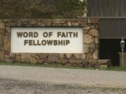 FILE - This 2016 image from video shows the entrance to the Word of Faith Fellowship church in Spindale, N.C. A member of the secretive North Carolina church has been sentenced to 10 months of home confinement for taking part in an unemployment fraud scheme benefiting businesses with ties to the congregation. Diane McKinny also received three years of probation at the federal court hearing Thursday, Sept. 26, 2019. She pleaded guilty in May to making a fraudulent claim for unemployment benefits for workers at a company run by a minister at Word of Faith Fellowship in Spindale.